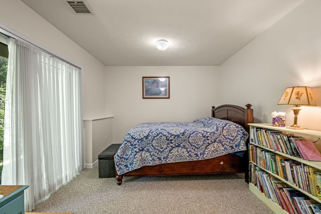 35 Collins Street, Unit 73 Danvers, MA 01923 - Photo 26 of 30 a bedroom with a bed and a book shelf