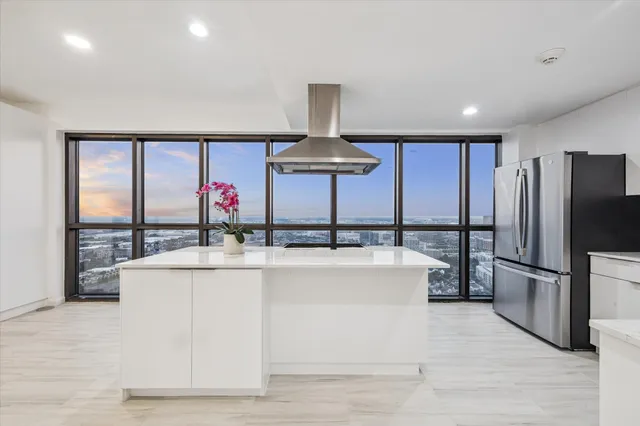a kitchen with stainless steel appliances a sink and a refrigerator