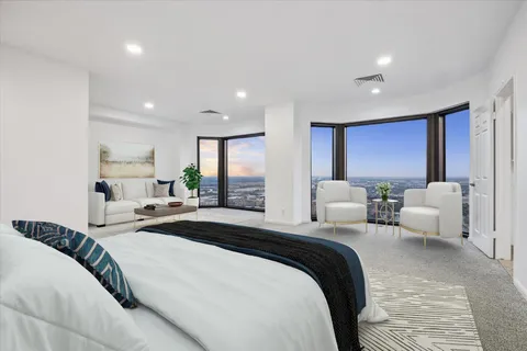 a bedroom with a bed and a large window