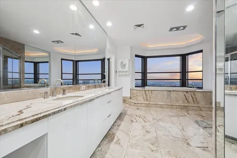 a large white kitchen with a large window