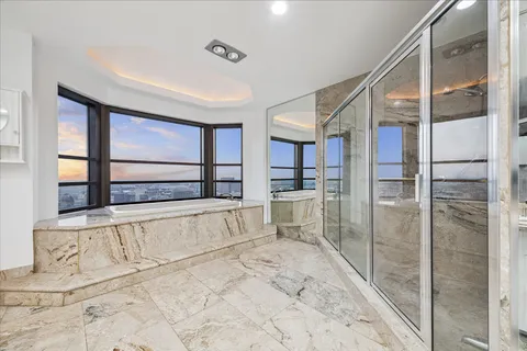 a spacious bathroom with a bathtub and a shower