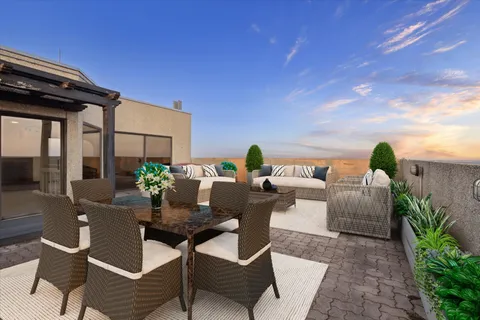 a view of a chairs and table in the patio