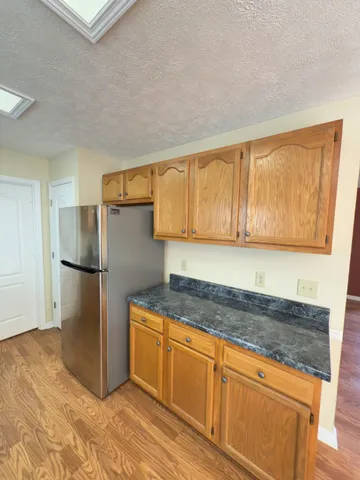 a kitchen with a refrigerator sink and cabinets
