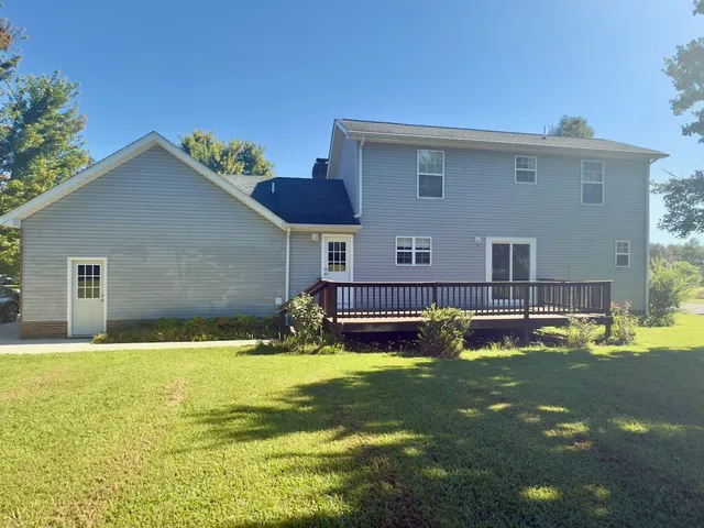 a house that has swimming pool in front of it
