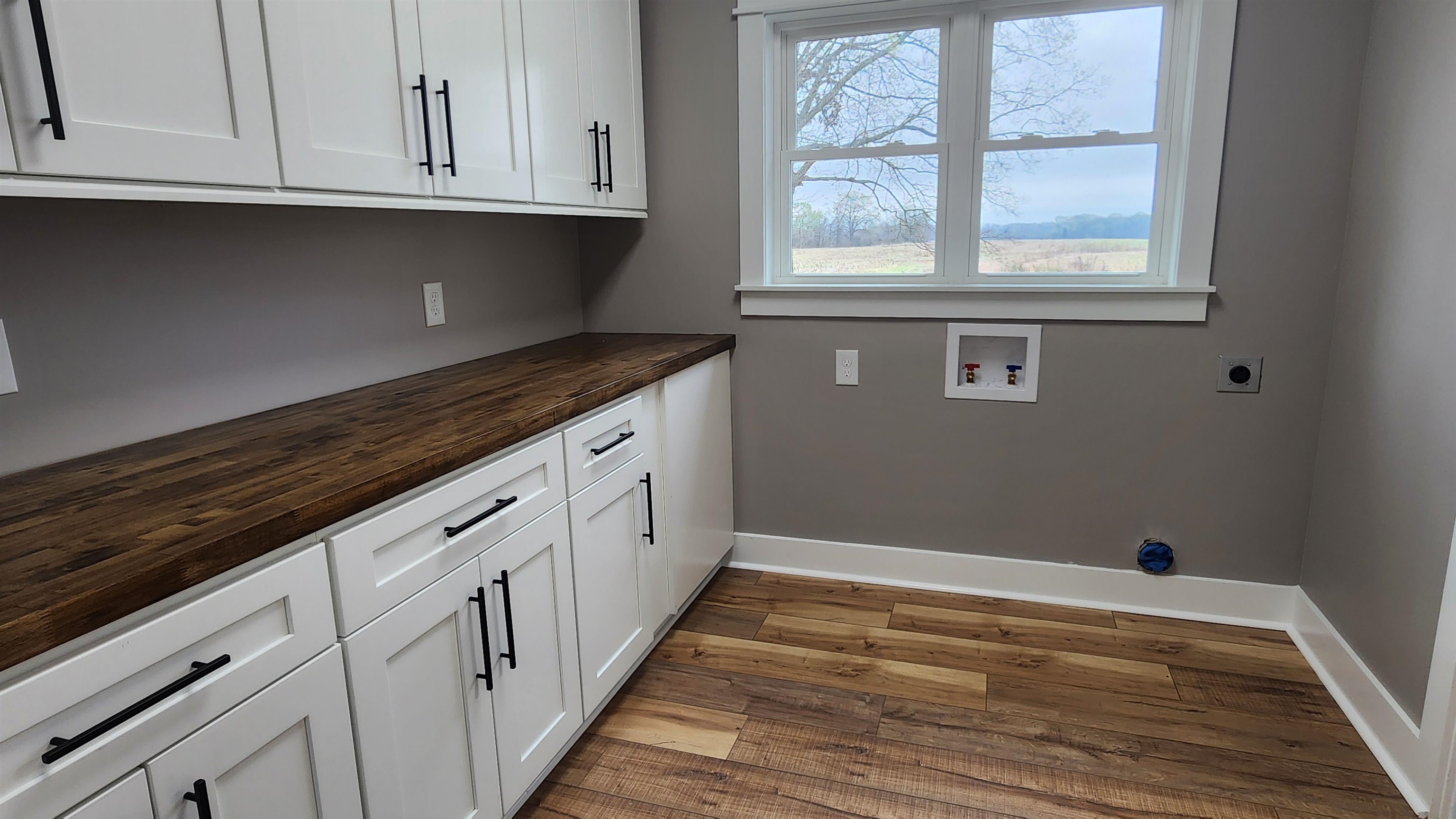 5200 Durhamville Road Ripley, TN 38063 - Photo 11 of 18 a kitchen with granite countertop white cabinets and window