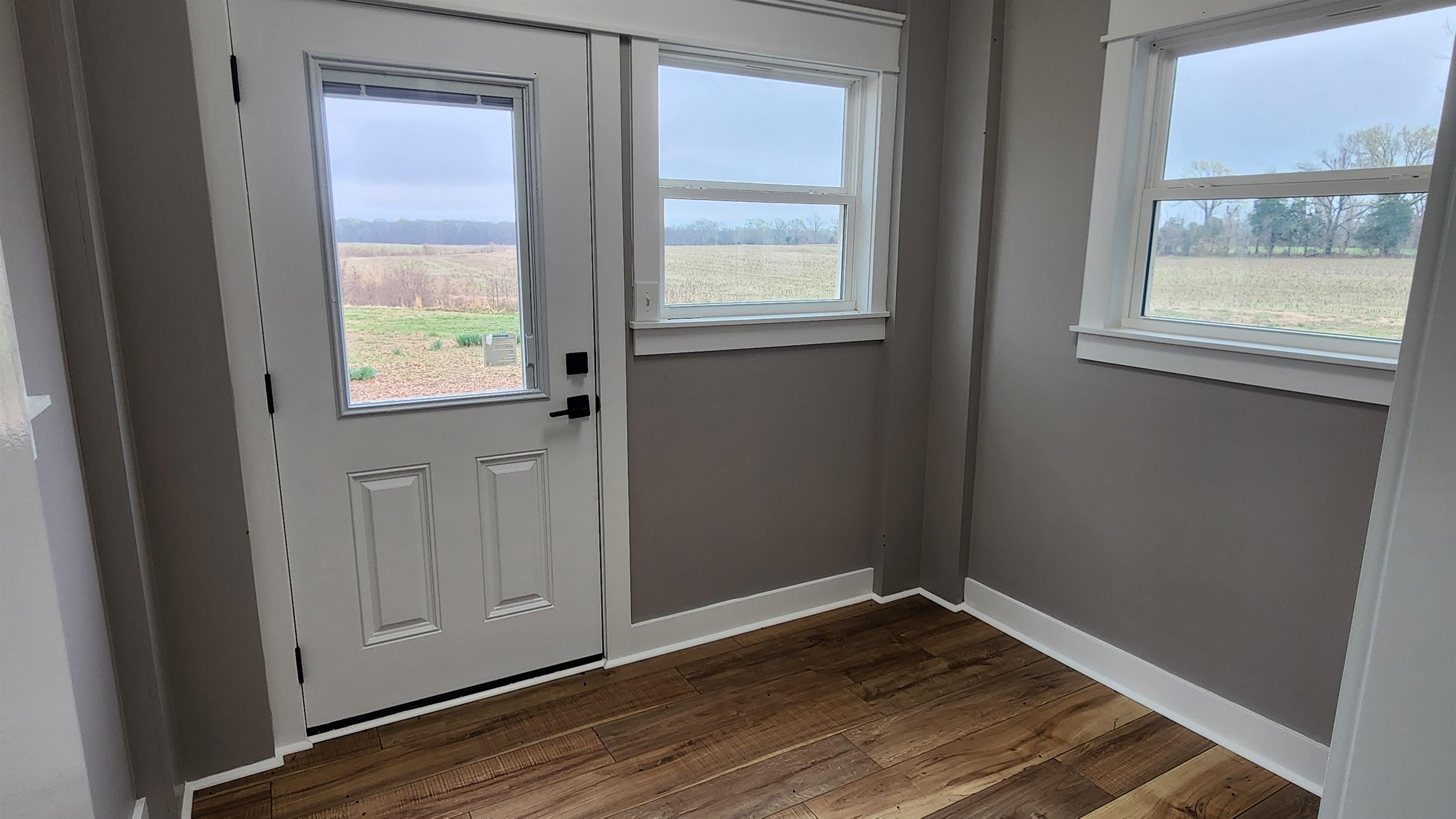 5200 Durhamville Road Ripley, TN 38063 - Photo 12 of 18 an empty room with wooden floor and windows