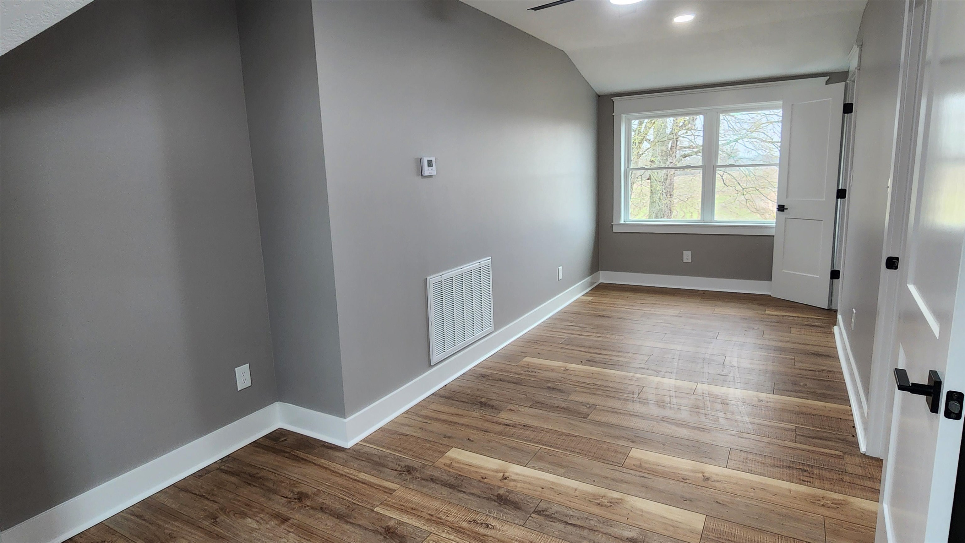5200 Durhamville Road Ripley, TN 38063 - Photo 13 of 18 wooden floor in an empty room with a window
