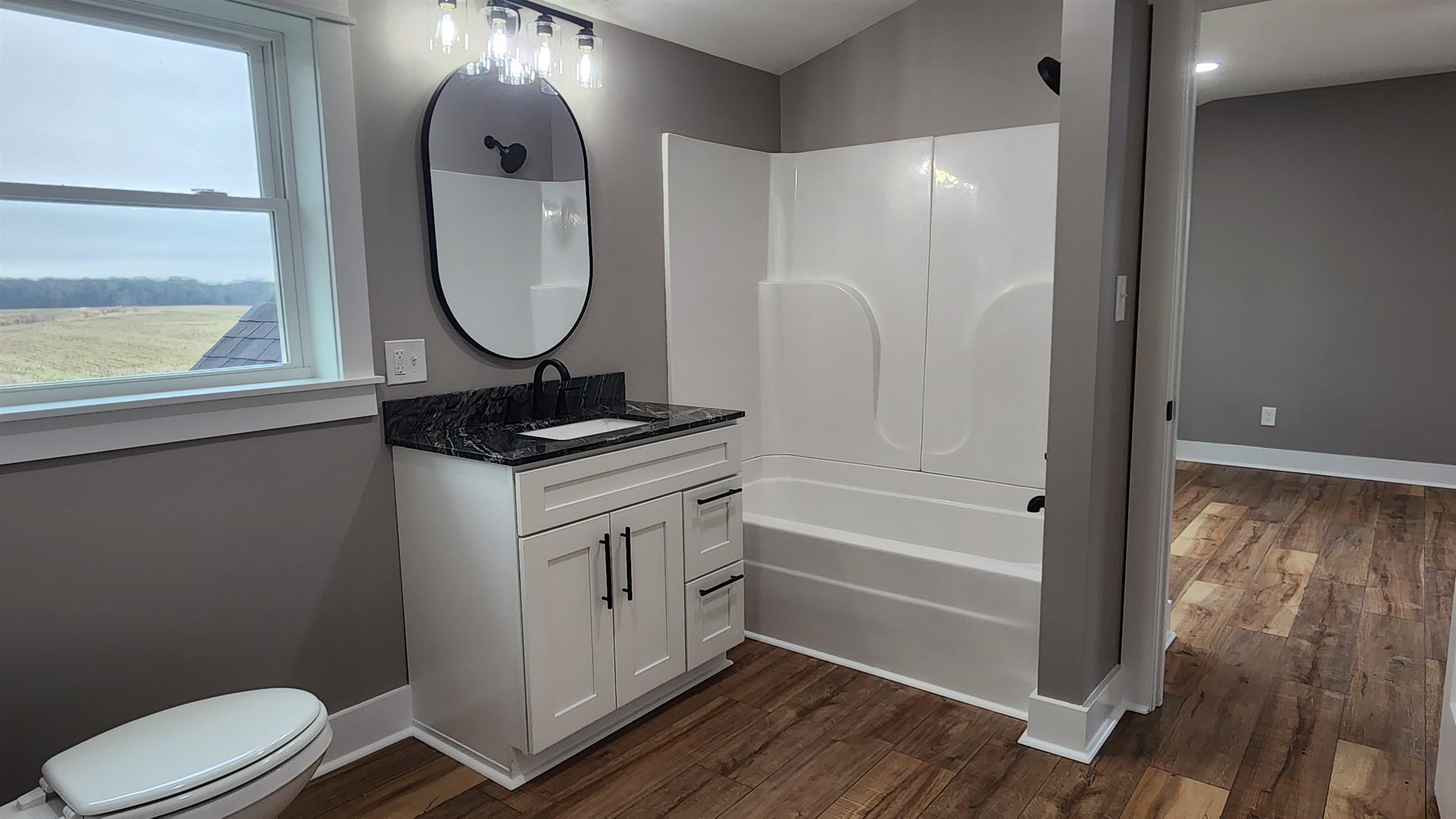 5200 Durhamville Road Ripley, TN 38063 - Photo 15 of 18 a bathroom with a toilet mirror and vanity
