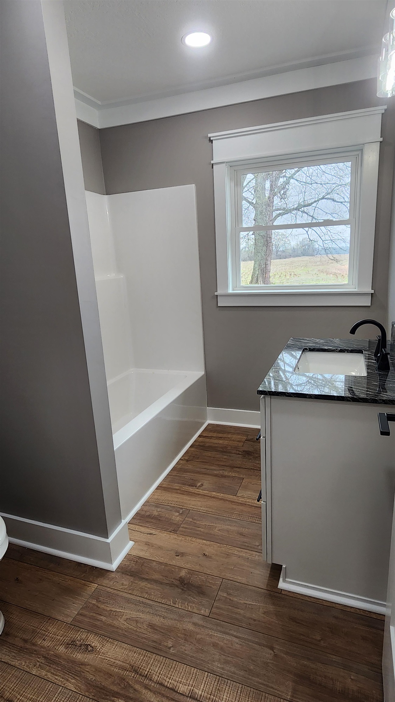 5200 Durhamville Road Ripley, TN 38063 - Photo 10 of 18 a view of an empty room with wooden floor and a window