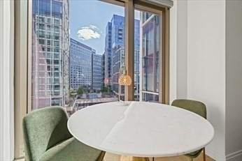 133 Seaport Boulevard, Unit 1017 Boston, MA 02210 - Photo 12 of 28 a bed sitting in a bedroom next to a window