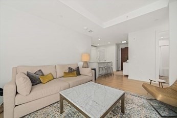 133 Seaport Boulevard, Unit 1017 Boston, MA 02210 - Photo 14 of 28 a living room with furniture and a table