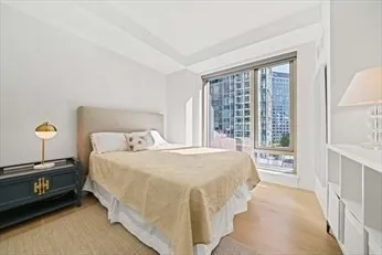 a bedroom with a bed and a mirror