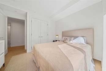 133 Seaport Boulevard, Unit 1017 Boston, MA 02210 - Photo 17 of 28 a bedroom with a bed and a mirror