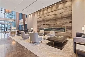 a lobby with furniture and a rug