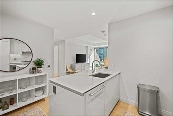 133 Seaport Boulevard, Unit 1017 Boston, MA 02210 - Photo 5 of 28 a kitchen with a sink cabinets and a stove