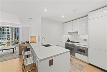 133 Seaport Boulevard, Unit 1017 Boston, MA 02210 - Photo 6 of 28 a kitchen that has a sink and a stove in it