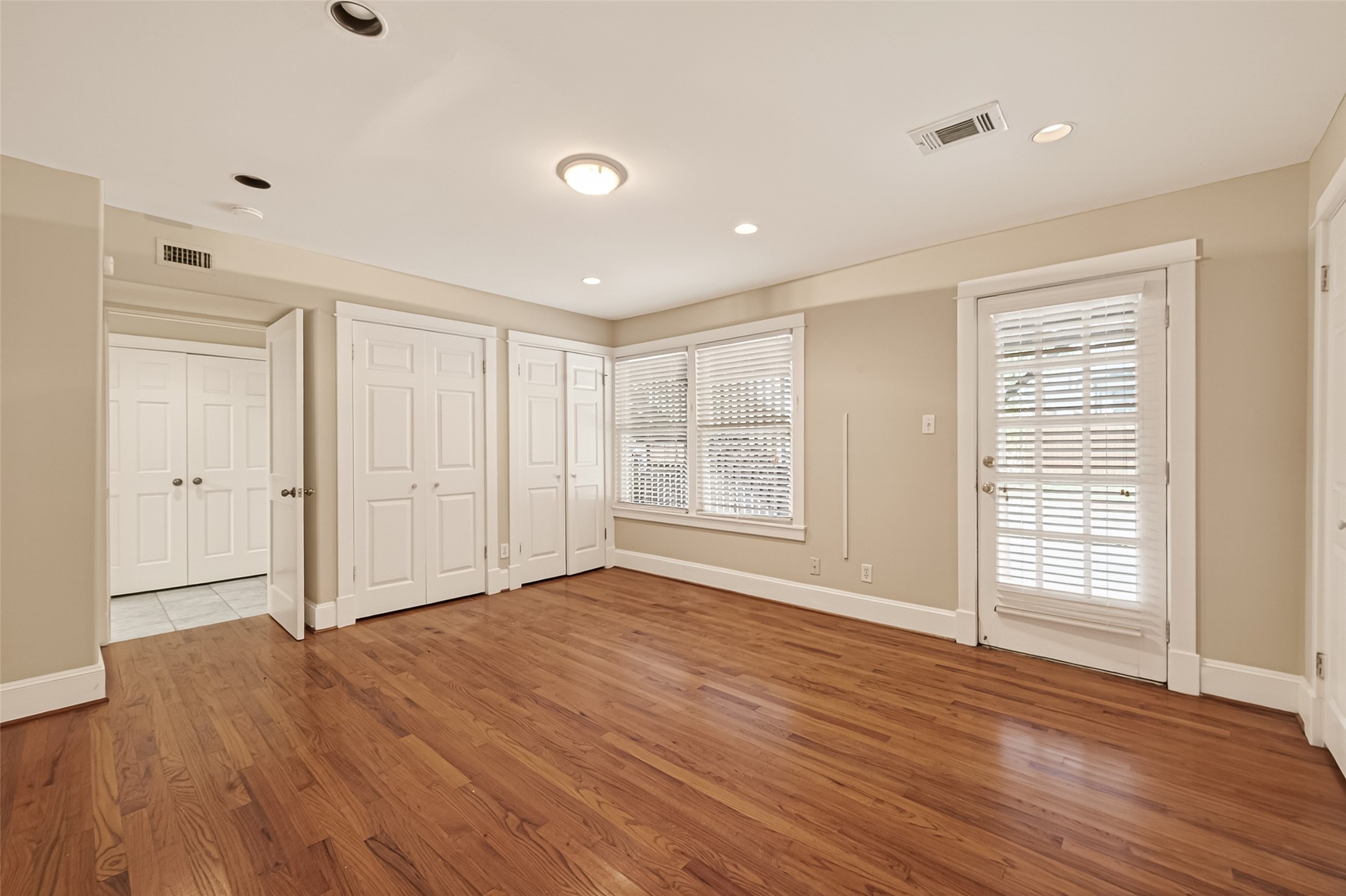 1807 Crocker Street, Unit A Houston, TX 77006 - Photo 18 of 37 a view of an empty room with wooden floor and a window
