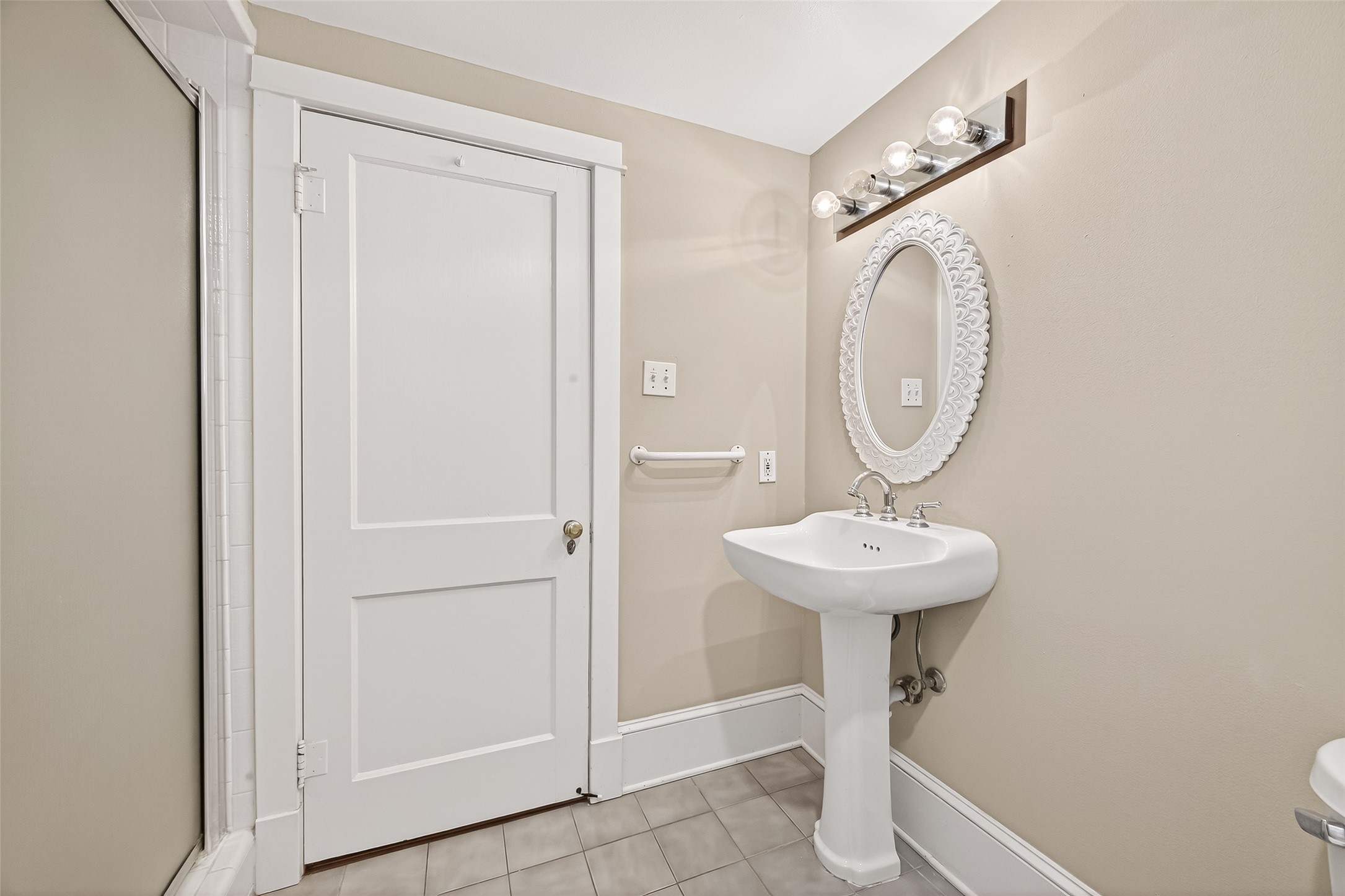 1807 Crocker Street, Unit A Houston, TX 77006 - Photo 27 of 37 a bathroom with a sink a toilet and mirror