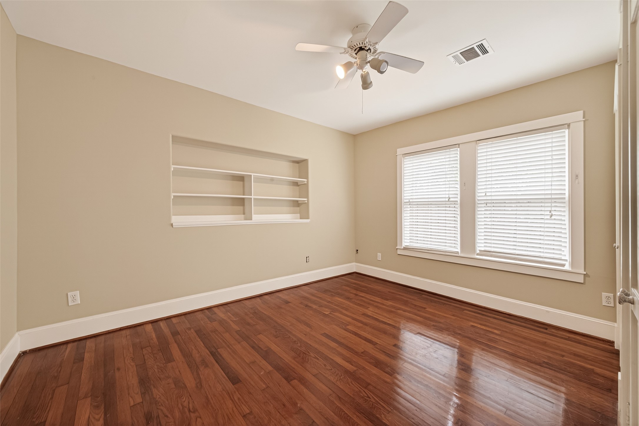 1807 Crocker Street, Unit A Houston, TX 77006 - Photo 28 of 37 a view of an empty room with a window and wooden floor