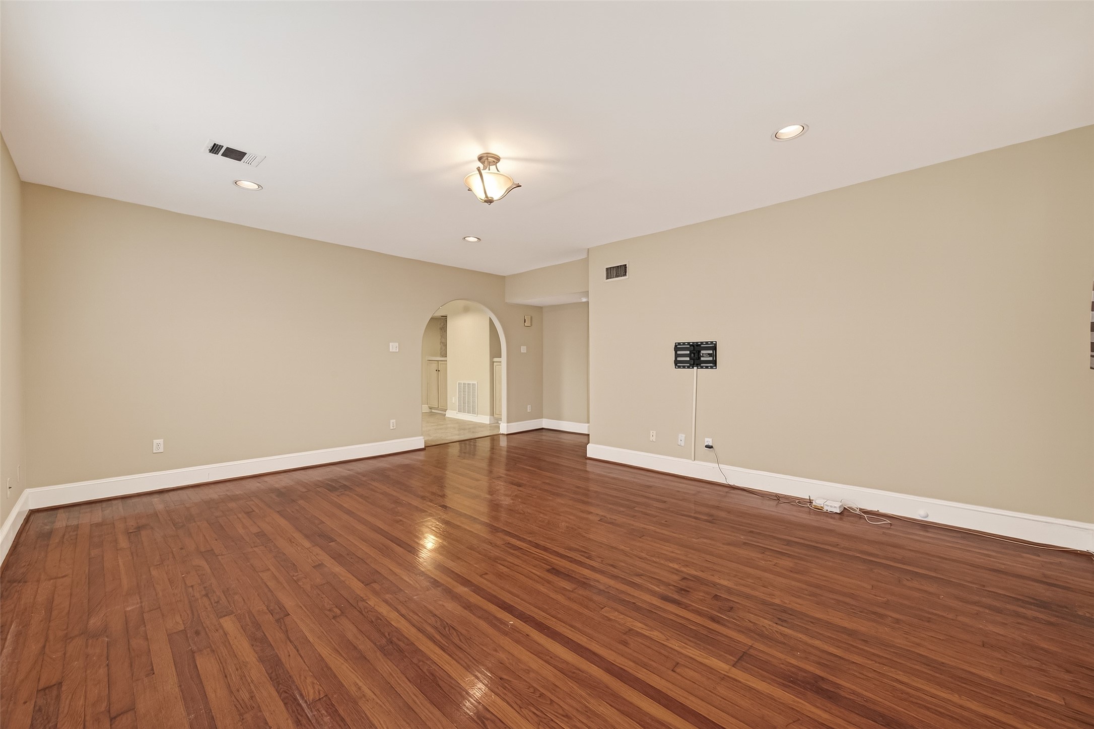 1807 Crocker Street, Unit A Houston, TX 77006 - Photo 3 of 37 a view of an empty room with wooden floor and a window