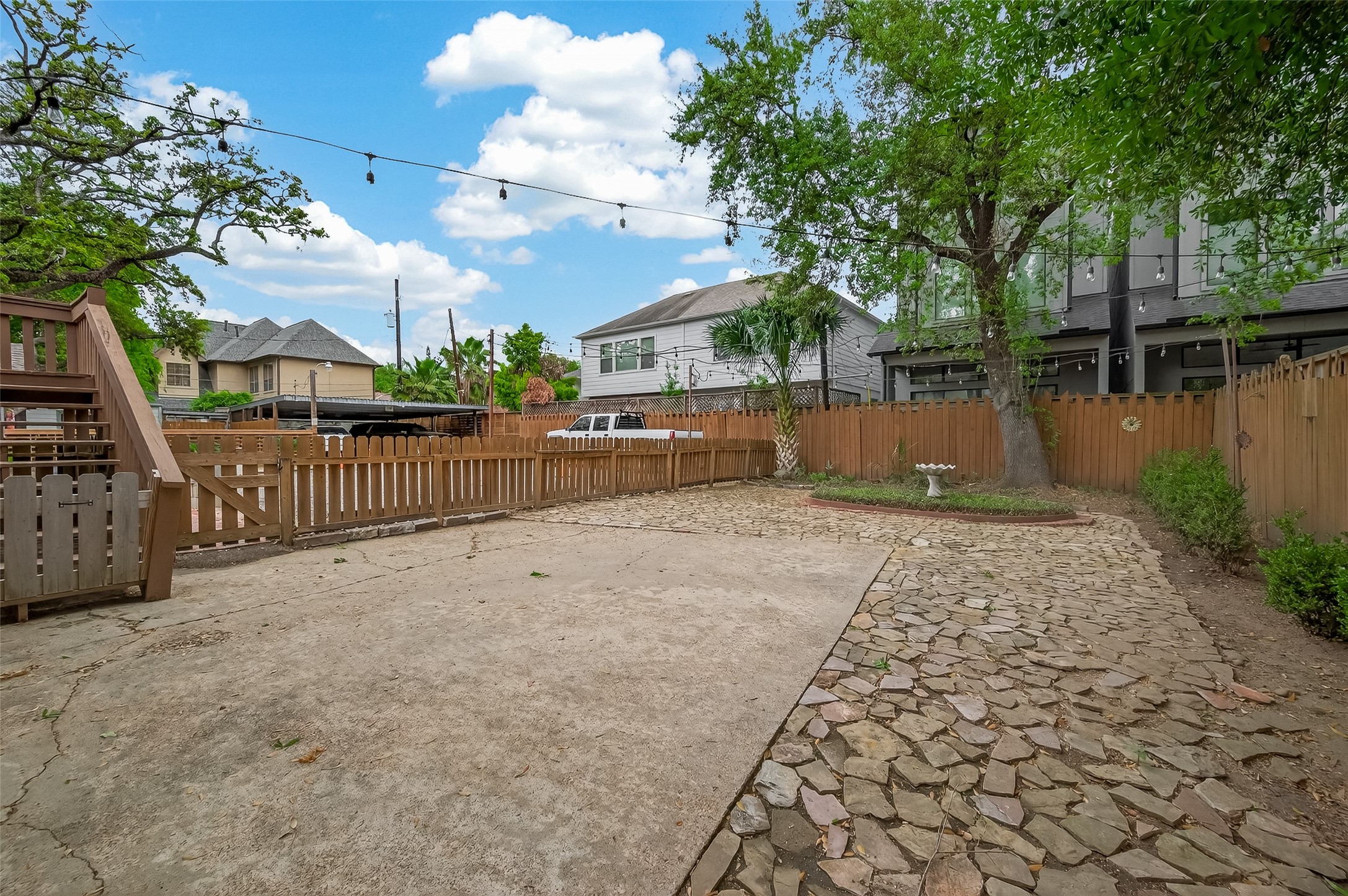 1807 Crocker Street, Unit A Houston, TX 77006 - Photo 32 of 37 A photo of the back yard space. The upstairs apartment uses the upper deck. Beyond the wood picket fence is a row of parking spaces. This is where you will have two assigned parking spots, next to the white truck.