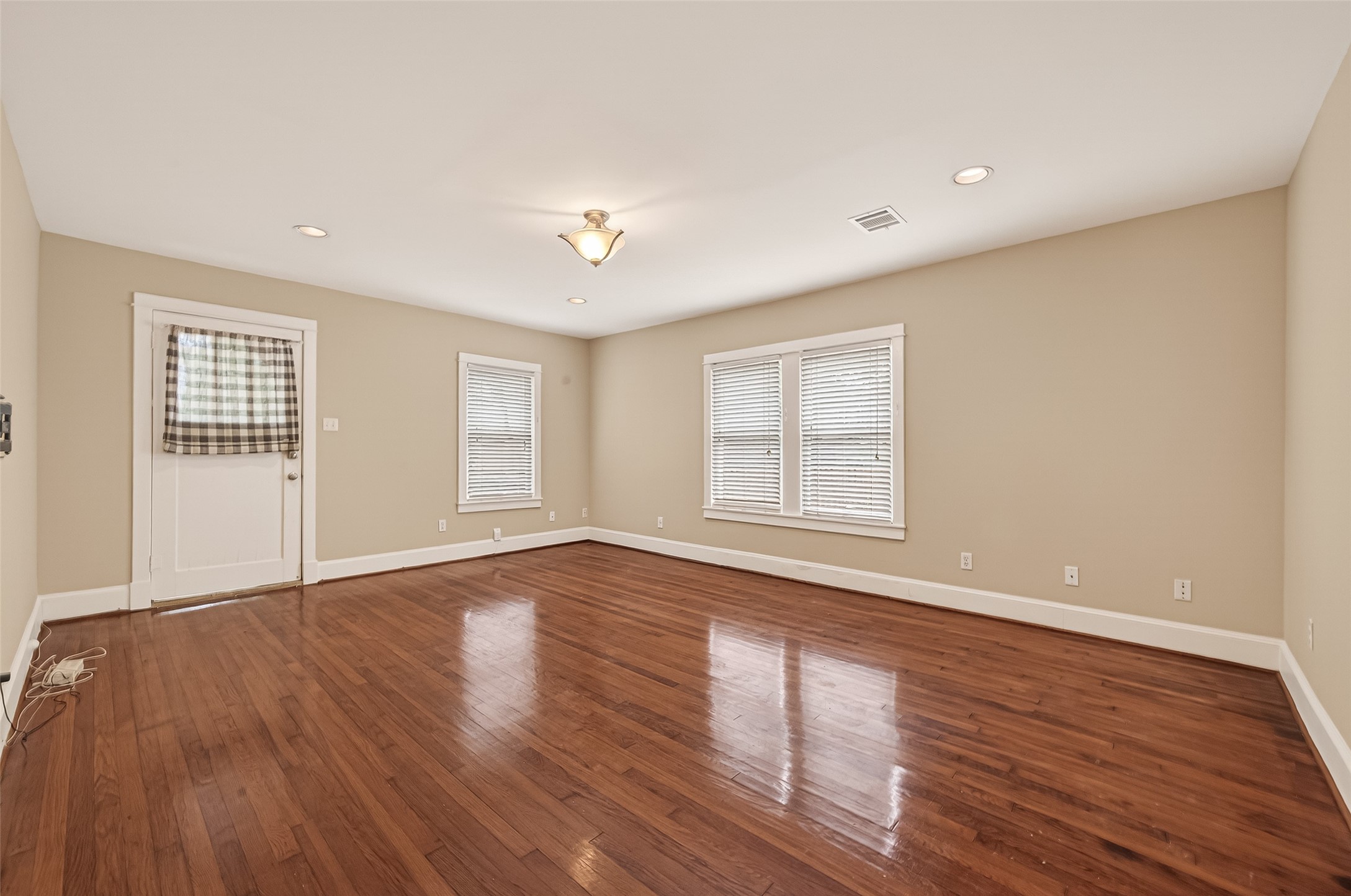 1807 Crocker Street, Unit A Houston, TX 77006 - Photo 4 of 37 a view of an empty room with wooden floor and a window