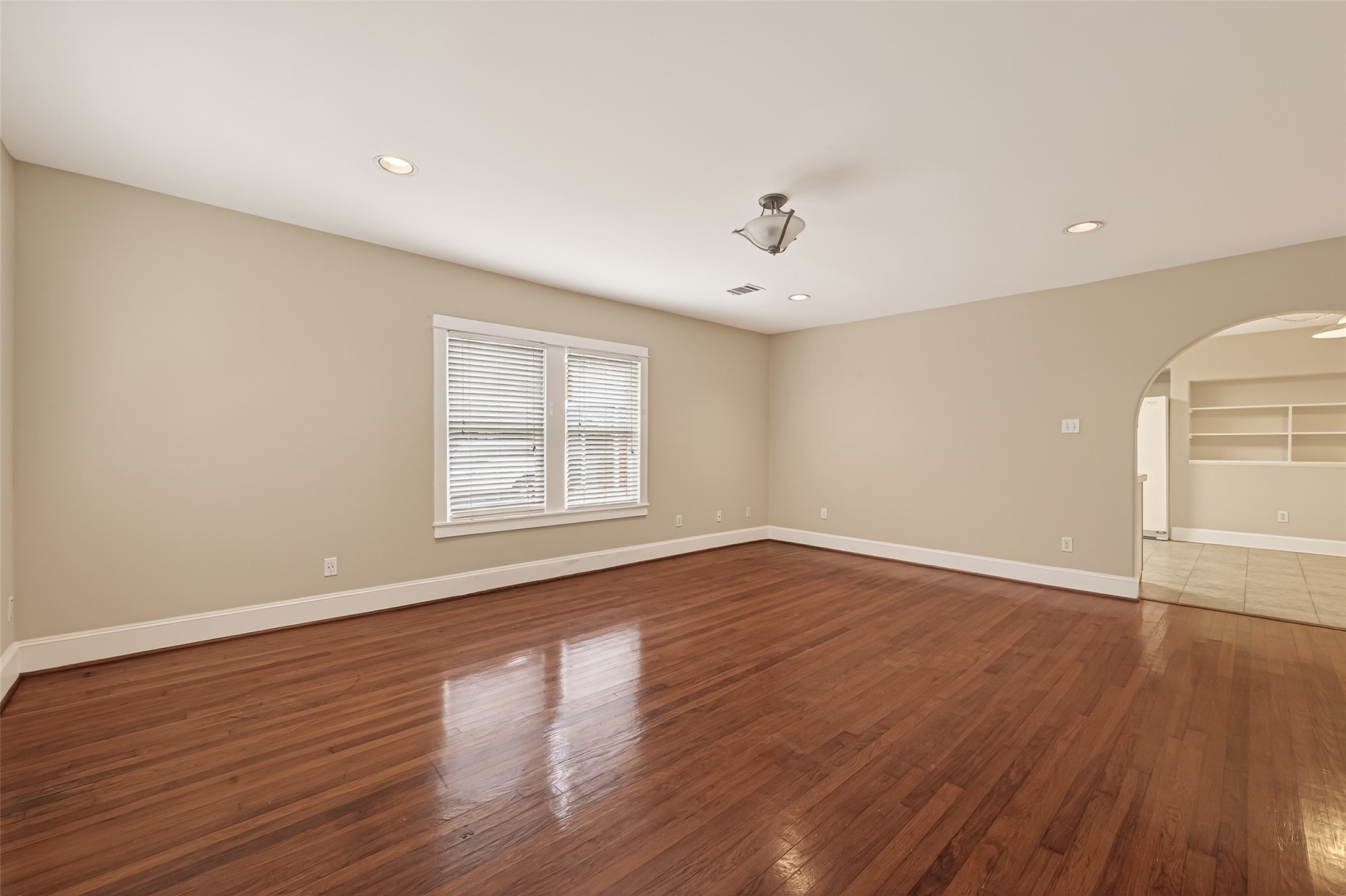 1807 Crocker Street, Unit A Houston, TX 77006 - Photo 5 of 37 a view of an empty room with wooden floor and a window