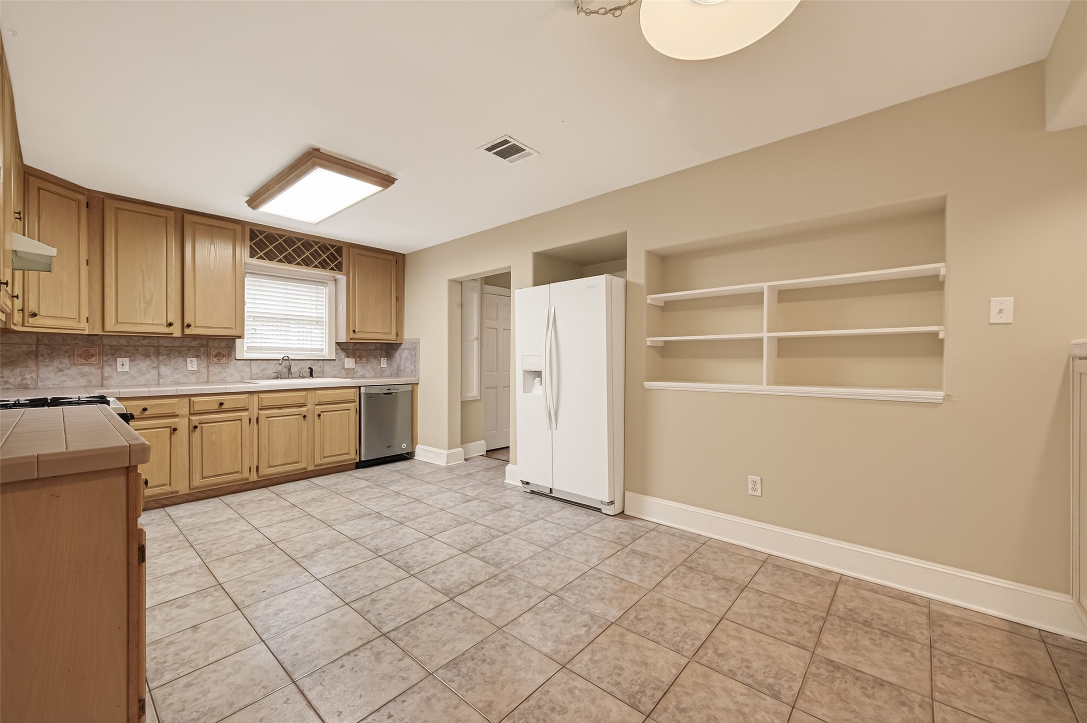 1807 Crocker Street, Unit A Houston, TX 77006 - Photo 7 of 37 a kitchen with a cabinets and white appliances
