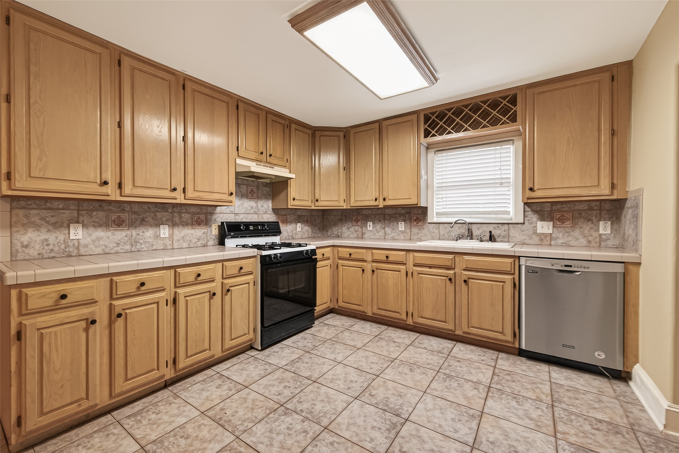 1807 Crocker Street, Unit A Houston, TX 77006 - Photo 8 of 37 a kitchen with stainless steel appliances granite countertop a stove sink and cabinets