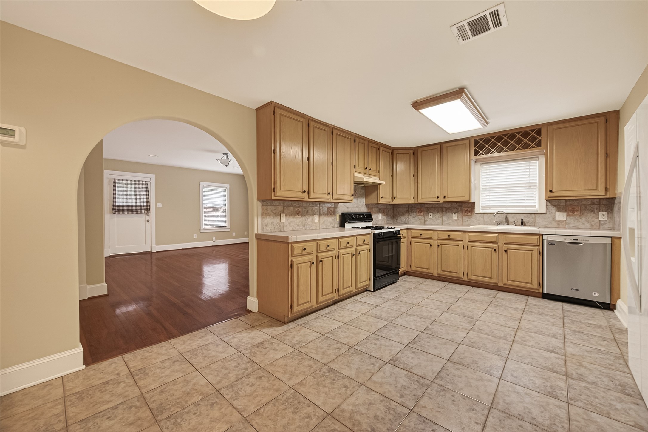 1807 Crocker Street, Unit A Houston, TX 77006 - Photo 9 of 37 a kitchen with a sink a stove cabinets and counter space