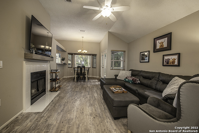 16807 Cedar Tree Way San Antonio, TX 78247 - Photo 12 of 30 a living room with furniture and a fireplace
