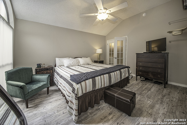 16807 Cedar Tree Way San Antonio, TX 78247 - Photo 13 of 30 a bedroom with a bed a couch and a window