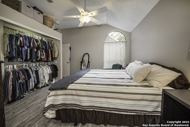 16807 Cedar Tree Way San Antonio, TX 78247 - Photo 16 of 30 a view of a bedroom with wooden floor and white cabinet