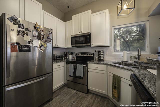 16807 Cedar Tree Way San Antonio, TX 78247 - Photo 4 of 30 a kitchen with stainless steel appliances granite countertop a refrigerator sink and stove