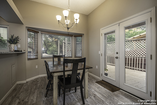 16807 Cedar Tree Way San Antonio, TX 78247 - Photo 7 of 30 a view of a dining room with furniture a chandelier and wooden floor