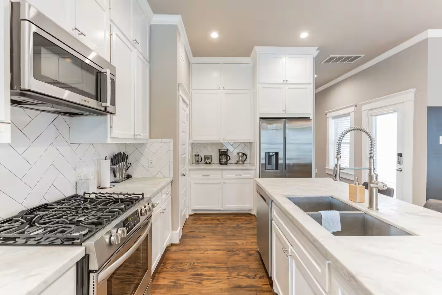 1006 Enid Street, Unit B Houston, TX 77009 - Photo 7 of 26 a kitchen with stainless steel appliances granite countertop a sink stove oven and white cabinets