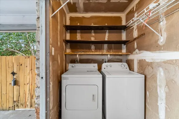a view of storage and utility room with washer and dryer