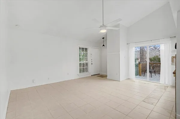 an empty room with entrance and windows