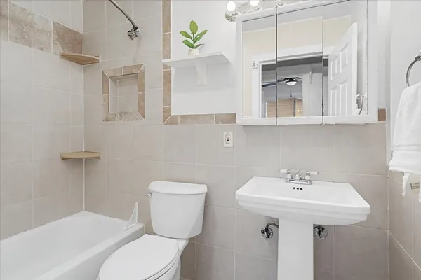 a bathroom with a sink a toilet and mirror