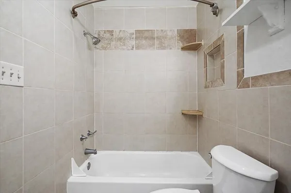 a white bath tub sitting next to a white toilet