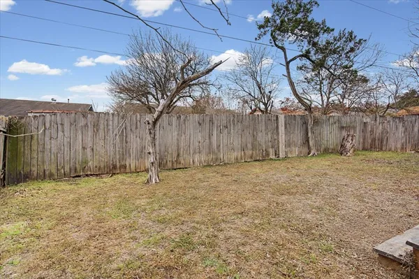 a view of house with a yard and seating area
