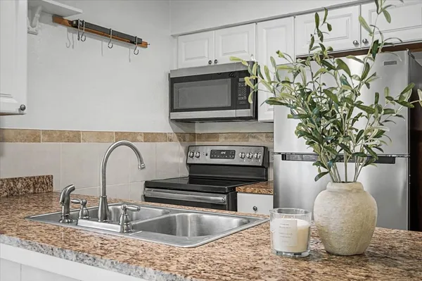 a kitchen with a faucet a sink and a stove