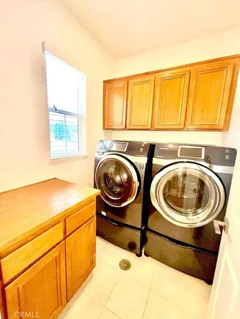 a utility room with sink dryer and washer