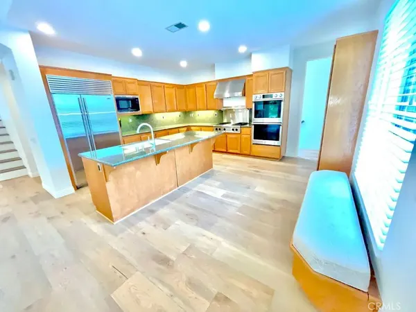 a view of kitchen with stainless steel appliances kitchen area and wooden floor