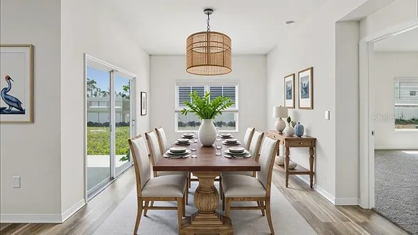 a view of a dining room with furniture window and wooden floor