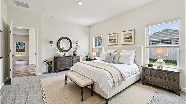 a bedroom with a bed a mirror and a window