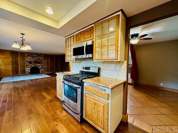 a kitchen with stainless steel appliances granite countertop a stove and a sink