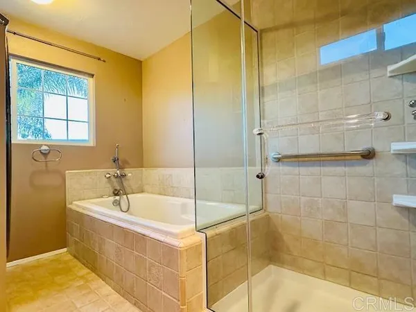 a bathroom with a bathtub and shower