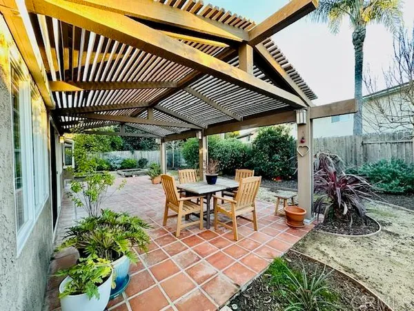 a view of a patio with a table chairs and a potted plant