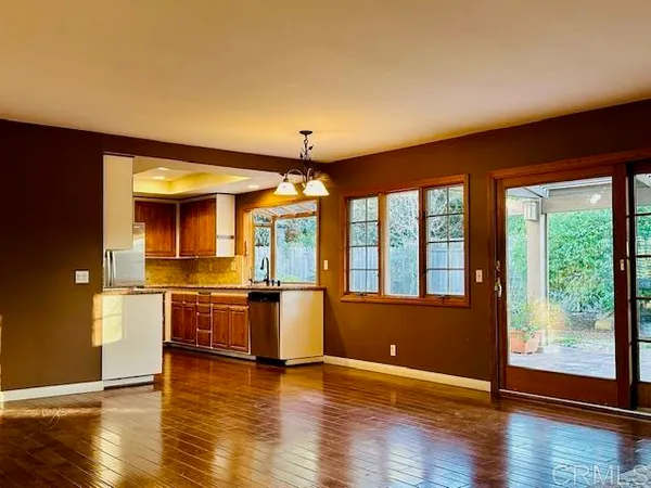 a open kitchen with stainless steel appliances granite countertop a stove and wooden floor